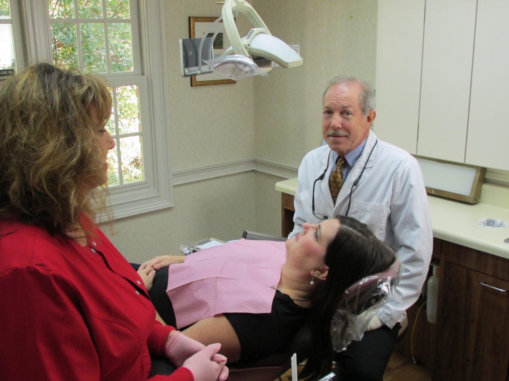 Dr. Rice, cosmetic dentistry athens ga, preparing for aesthetic dentistry services with patient and assistant